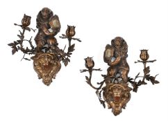 A PAIR OF CARVED, GESSO AND POLYCHROME DECORATED GILT METAL MOUNTED TWIN BRANCH WALL LIGHTS
