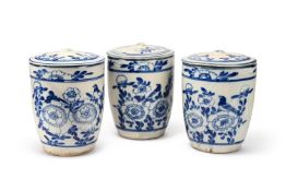 A SET OF THREE BLUE AND WHITE TIN-GLAZED EARTHENWARE LIDDED STORAGE JARS, LATE 19TH CENTURY