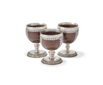 THREE SIMILAR SILVER MOUNTED COCONUT CUPS