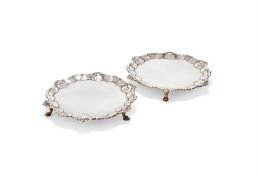 A PAIR OF GEORGE III SILVER SHAPED CIRCULAR WAITERS