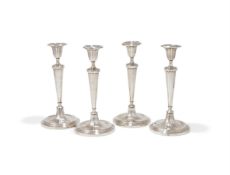 A SET OF FOUR GEORGE III SILVER CANDLESTICKS