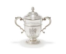 A SILVER TWIN HANDLED CUP AND COVER