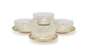 A SET OF FOUR GEORGE III SILVER GILT OVAL SALT CELLARS