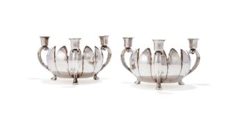 A PAIR OF SILVER COLOURED CANDLE HOLDERS
