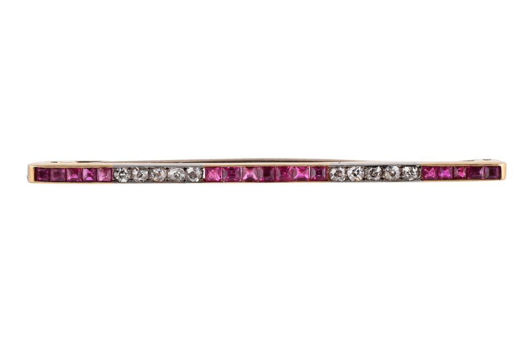 A DIAMOND AND RUBY BAR BROOCH