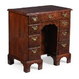 A GEORGE II BURR YEW KNEEHOLE DESK, CIRCA 1740