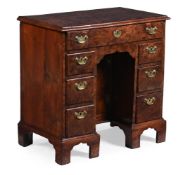 A GEORGE II BURR YEW KNEEHOLE DESK, CIRCA 1740
