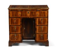 A GEORGE II FRUITWOOD, ASH FEATHERBANDED, BRASS MOUNTED KNEEHOLE DESK, CIRCA 1740