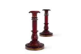 A PAIR OF RUBY OVERLAY GLASS CANDLESTICKS BOHEMIA