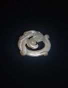 A Chinese carved white and russet jade 'Dragon' pendant