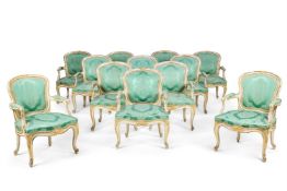 A SET OF TWELVE GEORGE III WHITE PAINTED AND PARCEL GILT ARMCHAIRS, ATTRIBUTED TO JOHN LINNELL