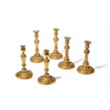 THREE PAIRS OF GILT BRONZE CANDLESTICKS, FRENCH, LATE 18TH OR EARLY 19TH CENTURY
