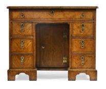 A GEORGE I BURR WALNUT AND CHEQUER BANDED KNEEHOLE DESK, CIRCA 1725