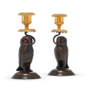 A PAIR OF CONTINENTAL PATINATED AND GILT BRONZE OWL CANDLESTICKS, LATE 19TH OR EARLY 20TH CENTURY