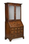 A GEORGE I WALNUT, BURR WALNUT AND FEATHERBANDED BUREAU BOOKCASE, CIRCA 1725