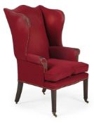 A RED UPHOLSTERED WING ARMCHAIR, EARLY 20TH CENTURY