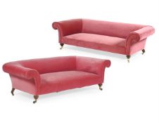 A PINK UPHOLSTERED CHESTERFIELD SOFA BY HOWARD & SONS, LATE 19TH CENTURY, AND ANOTHER MADE TO MATCH