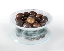 A GROUP OF SIXTEEN SPECIMEN CARVED HARDSTONE MODELS OF EGGS IN A GLASS BOWL, MODERN