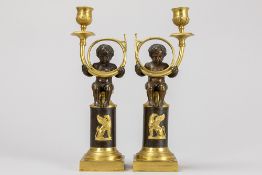 pair of early 19th Cent. Empire period candelabra in partly gilded bronze, each with a Cupid with