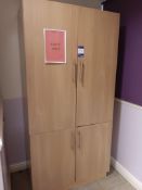 Wooden 4 door storage cupboard with quantity of glassware and crockery