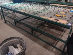 Hydraulic foot operated roller table with clamp