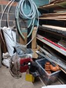 Contents of room to include various wood veneer sheets, carpet tiles, visqueen, plumbing fittings,