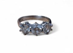 An 18ct white gold trilogy ring set with three round diamonds, colour G, SI 3, total carat weight