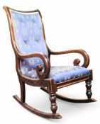 A 19th century scumbled mahogany rocking chair, scroll arms, upholstered in blue, c.1870