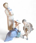 A Nao figure, of a boy with books, 28cm high, 233;  others, ballerina, 13cm high;   etc (3)