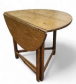 A late 18th century English oak joined folding cricket table,  circular top, block stretchers,