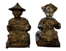 A pair early 20th century paktong/spelter nodding Chinese males, seated on cushions, 15cm high, c.