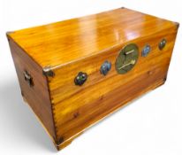 A Chinese camphor wood trunk, carrying handles to sides, bold circular escutcheon, 52cm high, 96cm