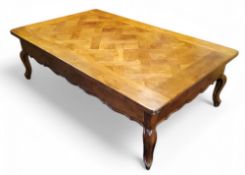 A substantial French rounded rectangular parquetry low coffee table, shaped apron, cabriole legs,