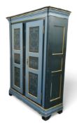A 19th century Swiss painted pine armoire, signed Ernst Rudin, oversailing cornice above two