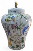 A large ceramic baluster shaped lamp base decorated with fanciful birds among foliage and wild