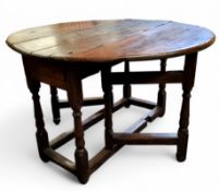 A 17th century English oak joined dropleaf gateleg oval tavern table, single pine lined drawer to