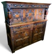 An English oak court cupboard, the upper section with a dental frieze above two block fronted
