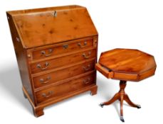A reproduction yew bureau,  the fall front with tooled leather writing surface above four