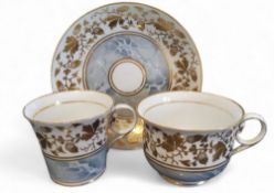 A Chamberlains Worcester coffee cup, teacup and saucer, banded with fruiting oak branches, above a