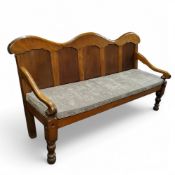 An early 19th century satinwood camel back settle, panelled back, scroll arms, turned forelegs, 92cm