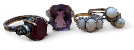 A 9ct gold and opal trilogy ring, set with a central oval opal, 7.6 x 5.6mm, flanked by two oval