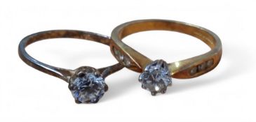 An 18ct gold diamond solitaire ring, eight claw set 0.25ct diamond, three channel set round diamonds