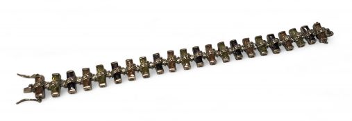 A unusual Cypriot silver bracelet each link set with alternating purple amethyst, Peridot and