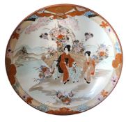 A Japanese Kutani charger, decorated with figures and fence, the border with geometrical shapes,