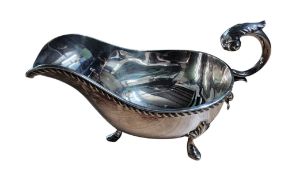 A George III style silver sauceboat, acanthus capped flying scroll handle, gadrooned rim, shell