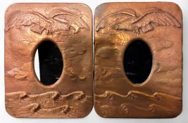 A pair of 20th century copper rounded rectangular easel photographs, embossed with bird pf prey