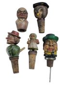 Five Austrian carved wood bottle stoppers,  in the form of amusing articulated characters