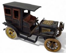 A Bing (Germany) tinplate clockwork limousine, black body and running boards, red seats, opening