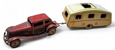 Mettoy tinplate clockwork saloon car with caravan comprising, 2 seater car, red and black, silver
