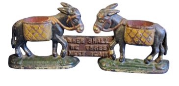 An early 20th century cast iron novelty fireside vesta/match striker and holder, cast with two